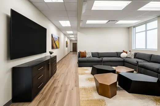 Spacious lounge area with modern furniture at All Points North detox center in Dallas.