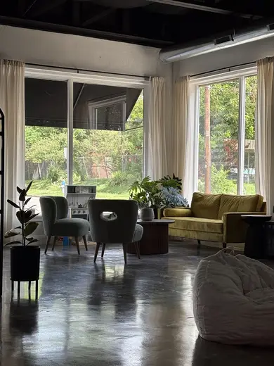 Sunlit shared living room at The Canary Community detox center in Dallas.