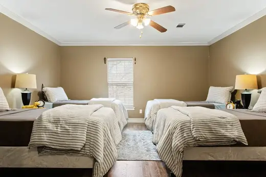 Cozy bedroom with two beds at The Magdalen House Men’s Location, an intensive outpatient program in Dallas.