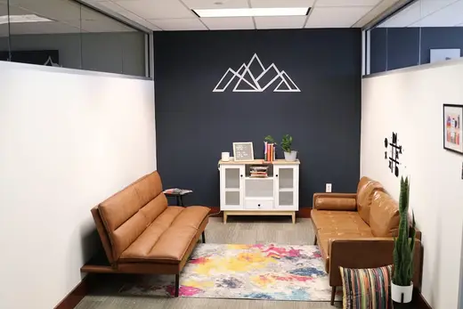 Cozy seating area with colorful rug at Clearfork Academy PHP & IOP - Carrollton, an intensive outpatient program in Dallas.