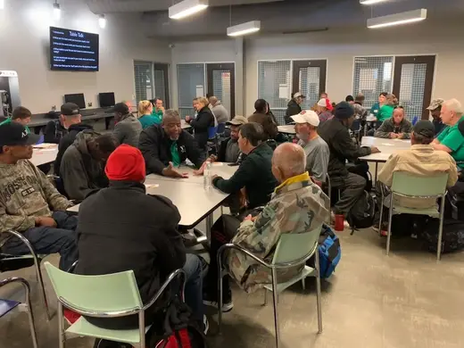 Community gathering in a spacious common area at OurCalling, a sober living home in Dallas.