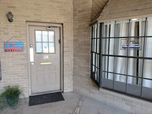 Welcoming entrance with a sign at Metro Relief, a sober living home in Dallas.
