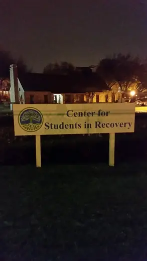 Illuminated sign for Center for Students in Recovery, a sober living home in Dallas.