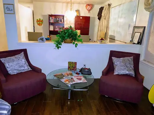 Cozy living area with two chairs at Shurruns House, a sober living home in Dallas.
