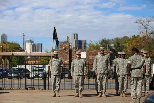 Soldiers in formation outside The Men of Nehemiah sober living home in Dallas.